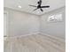 Bright bedroom features modern ceiling fan, neutral walls, a window, and light, wood-look flooring at 1475 S Eaton St, Lakewood, CO 80232