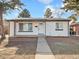 Well-kept single-story home with a neat front yard, sidewalk and inviting entrance at 1475 S Eaton St, Lakewood, CO 80232