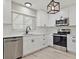 Modern kitchen featuring stainless steel appliances, white cabinets and subway tile backsplash at 1475 S Eaton St, Lakewood, CO 80232