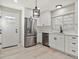 Modern kitchen featuring stainless steel appliances, white cabinets, and hardwood floors at 1475 S Eaton St, Lakewood, CO 80232