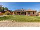 Spacious backyard featuring a well-maintained lawn and a covered patio perfect for outdoor entertaining at 5448 S Swadley Ct, Littleton, CO 80127