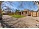 Backyard featuring a lush lawn, a storage shed and rock landscaping, offering a private outdoor space at 5448 S Swadley Ct, Littleton, CO 80127