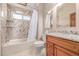 Bathroom features granite counters, tile shower, tub combo, and natural light from the window at 5448 S Swadley Ct, Littleton, CO 80127