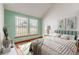 Bright bedroom featuring a bed with striped bedding, neutral decor, and natural light through two windows at 5448 S Swadley Ct, Littleton, CO 80127