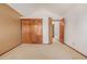 Bedroom featuring neutral carpet, a closet with paneled doors, and warm wall colors at 5448 S Swadley Ct, Littleton, CO 80127