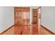 Bedroom features hardwood floors, a closet with paneled doors, and trim detailing at 5448 S Swadley Ct, Littleton, CO 80127