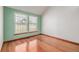 Bedroom featuring hardwood floors and natural light from the two windows at 5448 S Swadley Ct, Littleton, CO 80127