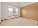 Bedroom featuring a window with bright natural light, neutral carpet, and warm wall colors at 5448 S Swadley Ct, Littleton, CO 80127