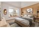 Bright bedroom featuring a bed, window seat, and decor; offering a cozy and inviting atmosphere at 5448 S Swadley Ct, Littleton, CO 80127