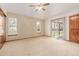 Bedroom features a ceiling fan, two windows, and a sliding glass door providing backyard access at 5448 S Swadley Ct, Littleton, CO 80127
