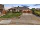 Charming single-Gathering home with a well-manicured lawn, mature landscaping, and a spacious driveway at 5448 S Swadley Ct, Littleton, CO 80127