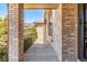 Covered front porch showing the entry door with sidelights and brick facade at 5448 S Swadley Ct, Littleton, CO 80127