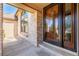 Inviting front entrance featuring an elegant wood door with glass accents and brick detailing at 5448 S Swadley Ct, Littleton, CO 80127