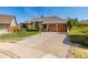 A beautifully landscaped yard and wide driveway leading to a two-car garage enhance this home's curb appeal at 5448 S Swadley Ct, Littleton, CO 80127