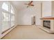 Bright living room features large windows, vaulted ceilings, and a cozy fireplace at 5448 S Swadley Ct, Littleton, CO 80127