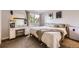 Bright bedroom with a vanity, a window view, carpet, and neutral bedding at 8450 Decatur St # 97, Westminster, CO 80031