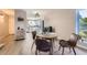 Dining area with seating for four, seamlessly connecting to the living room and kitchen at 8450 Decatur St # 97, Westminster, CO 80031