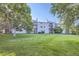 Exterior shot of home overlooking green grass and mature landscaping with balcony access at 8450 Decatur St # 97, Westminster, CO 80031