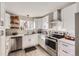 Bright, renovated kitchen with white cabinets, stainless steel appliances, and sleek countertops at 8450 Decatur St # 97, Westminster, CO 80031