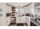 Bright, fully renovated kitchen with white cabinets, stainless steel appliances, and modern finishes at 8450 Decatur St # 97, Westminster, CO 80031