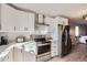 Bright kitchen featuring stainless steel appliances, white cabinets, and marble backsplash at 8450 Decatur St # 97, Westminster, CO 80031