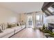 Bright living room featuring a comfortable sofa, modern fireplace, and sliding glass doors to a balcony at 8450 Decatur St # 97, Westminster, CO 80031