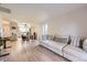 Spacious living area next to dining and kitchen spaces with sofa and laminate wood flooring at 8450 Decatur St # 97, Westminster, CO 80031