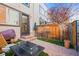 Outdoor patio area with stylish seating, a fire pit, and lush artificial grass, perfect for entertaining at 2801 W 23Rd Ave, Denver, CO 80211