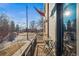 Balcony view overlooking a street with table and a small American flag waving proudly at 2801 W 23Rd Ave, Denver, CO 80211