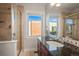 A well-lit bathroom features tiled shower with glass door and modern vanity with sink at 2801 W 23Rd Ave, Denver, CO 80211