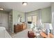 This Bedroom features a changing table, comfortable armchair and a bright window with charming patterned curtains at 2801 W 23Rd Ave, Denver, CO 80211
