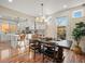 Bright dining area featuring a wooden table, elegant chandelier, and easy access to the modern kitchen and outdoor area at 2801 W 23Rd Ave, Denver, CO 80211