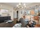 Bright dining area with a wooden table set beneath a stylish chandelier, adjacent to the modern kitchen at 2801 W 23Rd Ave, Denver, CO 80211