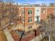Striking multi-story brick home with arched windows, lush landscaping, and inviting front entrance at 2801 W 23Rd Ave, Denver, CO 80211