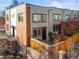 A modern multi-story home with a brick facade, fenced yard, and neutral siding at 2801 W 23Rd Ave, Denver, CO 80211