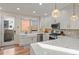 Bright kitchen with white cabinetry, marble countertops, stainless steel appliances and access to outdoors at 2801 W 23Rd Ave, Denver, CO 80211