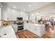 Modern white kitchen featuring stainless steel appliances, marble countertops, and stylish lighting fixtures at 2801 W 23Rd Ave, Denver, CO 80211