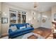 Inviting living room featuring a cozy blue sofa and natural light from the large window at 2801 W 23Rd Ave, Denver, CO 80211