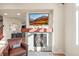Comfortable living room featuring a stone fireplace, mounted TV, and natural light from a nearby window at 2801 W 23Rd Ave, Denver, CO 80211