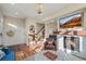 Inviting living room with a cozy fireplace, mounted TV, staircase access, and warm hardwood floors at 2801 W 23Rd Ave, Denver, CO 80211