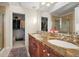 The main bathroom has a dual sink vanity, a framed mirror, and a walk-in closet at 2801 W 23Rd Ave, Denver, CO 80211