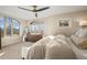 The bright main bedroom features large windows with beautiful views and a ceiling fan at 2801 W 23Rd Ave, Denver, CO 80211