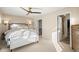 Bright main bedroom featuring a ceiling fan, ensuite bath, and walk-in closet at 2801 W 23Rd Ave, Denver, CO 80211