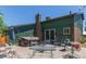 Backyard featuring green siding, brick foundation, hot tub, and patio furniture at 9400 W Burgundy Ave, Littleton, CO 80123