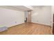 Unfinished basement featuring laminate wood flooring, white walls and neutral accents at 9400 W Burgundy Ave, Littleton, CO 80123