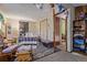 Bedroom featuring a bed, stone accent wall, closet, and access to other rooms at 9400 W Burgundy Ave, Littleton, CO 80123