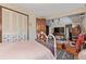 Bedroom featuring a bed, closet, stone accent wall, TV, and rocking chairs at 9400 W Burgundy Ave, Littleton, CO 80123