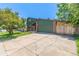 Two-story home with a spacious driveway, mature trees, and well-kept lawn, offering comfortable living at 9400 W Burgundy Ave, Littleton, CO 80123