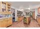 Spacious kitchen with wood cabinets, tiled floor, and center island at 9400 W Burgundy Ave, Littleton, CO 80123