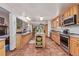 Large kitchen with an island, stainless steel appliances, granite countertops, and a view into the living room at 9400 W Burgundy Ave, Littleton, CO 80123